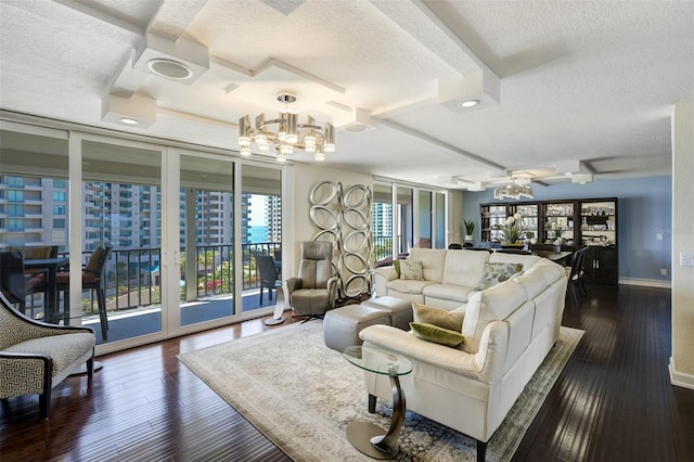 1581 Gulf Blvd Unit 701N, Clearwater Beach, FL 33767 - living room featuring a chandelier, a textured ceiling, dark wood-style flooring, and coffered ceiling