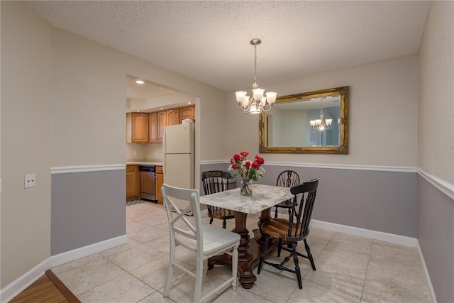 247 Los Prados Dr Unit 1123, Safety Harbor, FL 34695 - dining area featuring a chandelier, a textured ceiling, and light tile patterned flooring