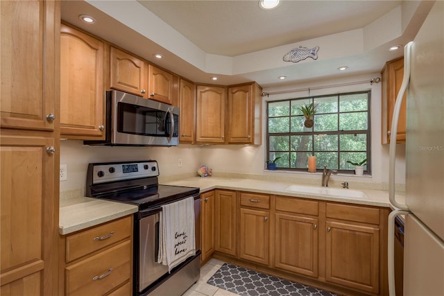 247 Los Prados Dr Unit 1123, Safety Harbor, FL 34695 - kitchen featuring stainless steel appliances, light countertops, recessed lighting, brown cabinets, and light tile patterned floors