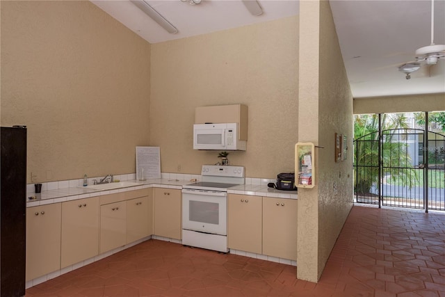 247 Los Prados Dr Unit 1123, Safety Harbor, FL 34695 - kitchen featuring white appliances, a textured wall, and light tile patterned floors