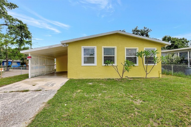 1903 24th St, Sarasota, FL 34234 - view of side of home with driveway, stucco siding, and a carport