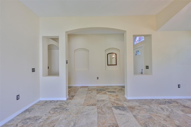 10430 Crestfield Dr, Riverview, FL 33569 - unfurnished room with arched walkways and stone finish flooring