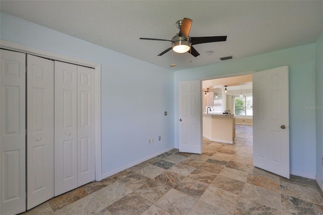 10430 Crestfield Dr, Riverview, FL 33569 - unfurnished bedroom with light stone finish floors, a closet, and ceiling fan