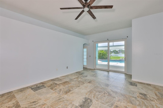 10430 Crestfield Dr, Riverview, FL 33569 - spare room with stone finish flooring, a ceiling fan, and arched walkways
