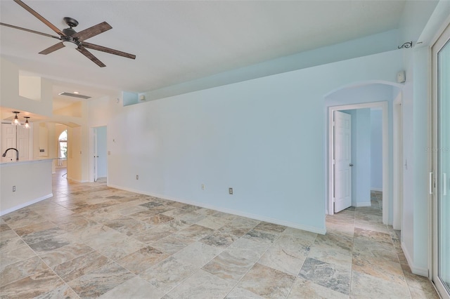 10430 Crestfield Dr, Riverview, FL 33569 - unfurnished room with arched walkways, ceiling fan, light stone finish flooring, and a chandelier