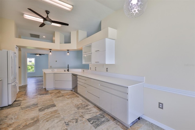 10430 Crestfield Dr, Riverview, FL 33569 - kitchen with freestanding refrigerator, a peninsula, ceiling fan, white cabinetry, and light stone finish floors