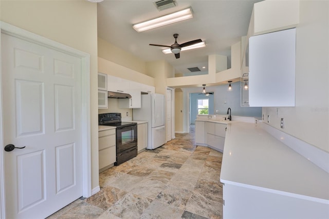 10430 Crestfield Dr, Riverview, FL 33569 - kitchen with black electric range oven, freestanding refrigerator, under cabinet range hood, white cabinetry, and light countertops