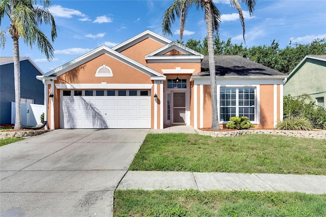 318 Lookout Dr, Apollo Beach, FL 33572 - ranch-style home featuring stucco siding, a garage, concrete driveway, and a front lawn