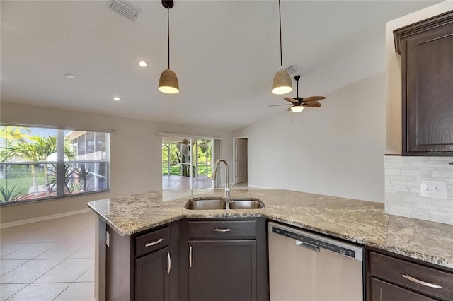 318 Lookout Dr, Apollo Beach, FL 33572 - kitchen with stainless steel dishwasher, dark brown cabinets, a ceiling fan, tasteful backsplash, and lofted ceiling