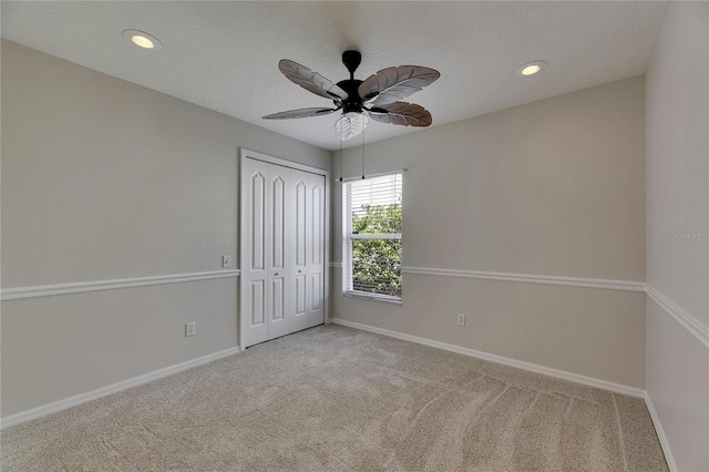 318 Lookout Dr, Apollo Beach, FL 33572 - unfurnished bedroom with carpet, a closet, recessed lighting, ceiling fan, and a textured ceiling