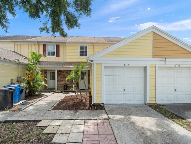 6114 Oak Cluster Cir, Tampa, FL 33634 - view of front of house featuring concrete driveway and board and batten siding