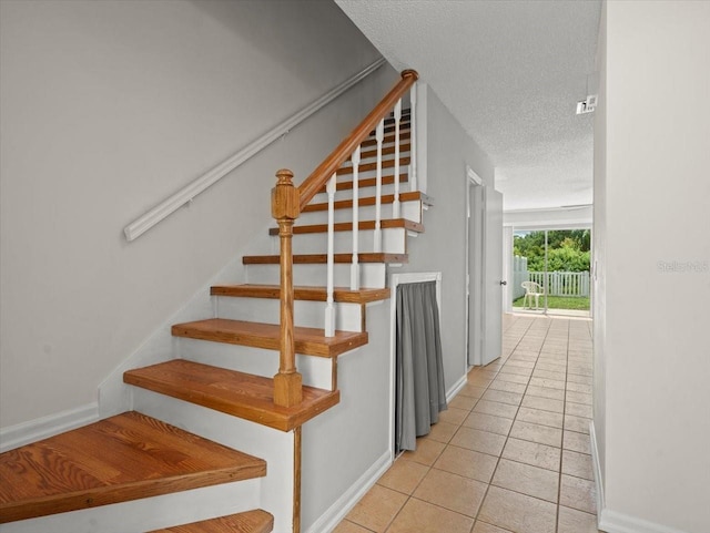 6114 Oak Cluster Cir, Tampa, FL 33634 - stairway with a textured ceiling and tile patterned flooring