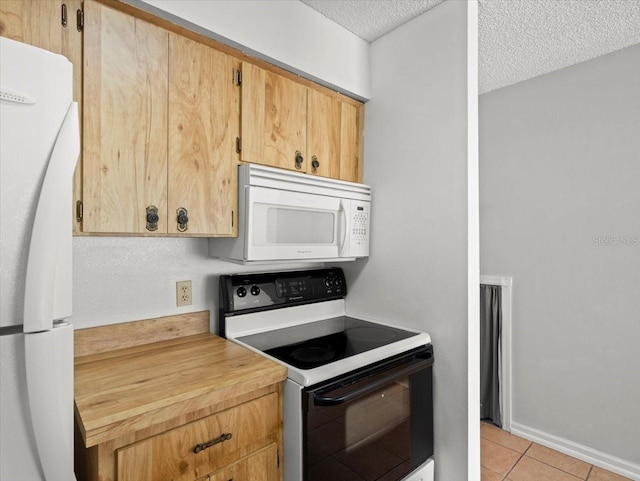 6114 Oak Cluster Cir, Tampa, FL 33634 - kitchen featuring white appliances, a textured ceiling, and light tile patterned flooring