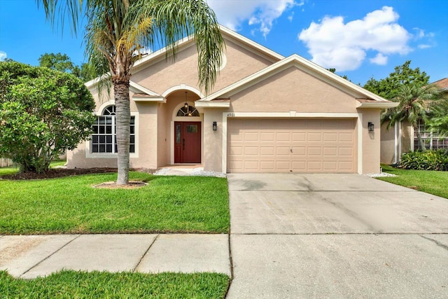 4901 Windingbrook Trl, Wesley Chapel, FL 33544 - mediterranean / spanish-style house with stucco siding, a garage, driveway, and a front yard