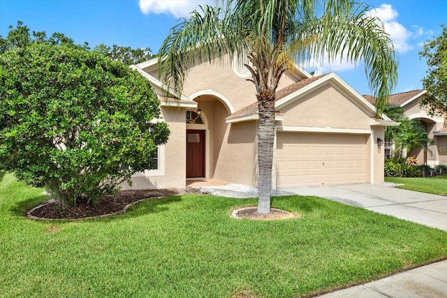 4901 Windingbrook Trl, Wesley Chapel, FL 33544 - view of front facade with stucco siding, a garage, concrete driveway, and a front yard