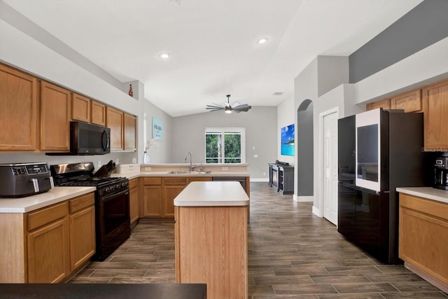 4901 Windingbrook Trl, Wesley Chapel, FL 33544 - kitchen featuring black appliances, a peninsula, dark wood-type flooring, a ceiling fan, and light countertops