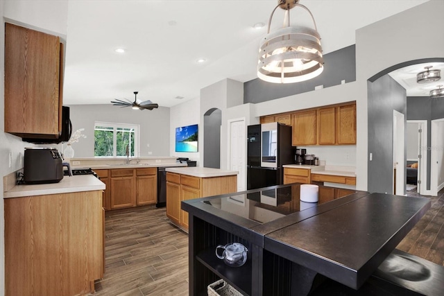 4901 Windingbrook Trl, Wesley Chapel, FL 33544 - kitchen featuring arched walkways, freestanding refrigerator, ceiling fan, a center island, and recessed lighting
