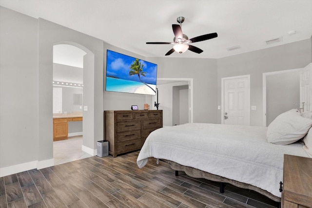 4901 Windingbrook Trl, Wesley Chapel, FL 33544 - bedroom with wood finished floors, arched walkways, ceiling fan, and ensuite bath