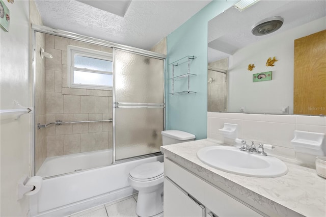 10730 Premier Ave, Port Richey, FL 34668 - full bath with vanity, shower / bath combination with glass door, a textured ceiling, and tile patterned floors