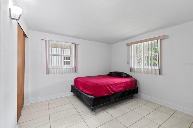 10730 Premier Ave, Port Richey, FL 34668 - bedroom with multiple windows and tile patterned floors