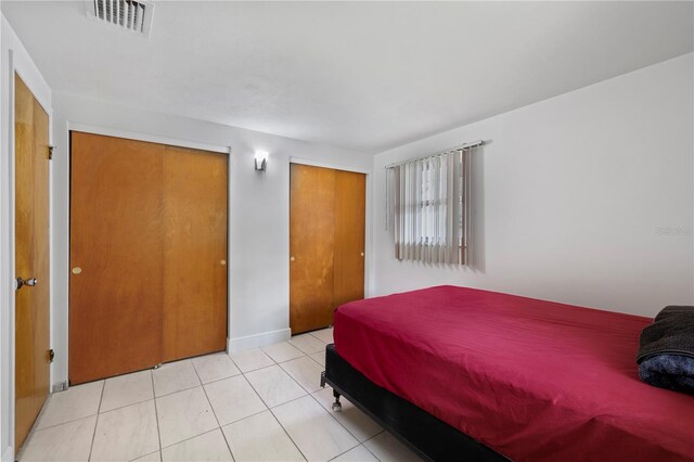10730 Premier Ave, Port Richey, FL 34668 - bedroom with light tile patterned flooring and baseboards