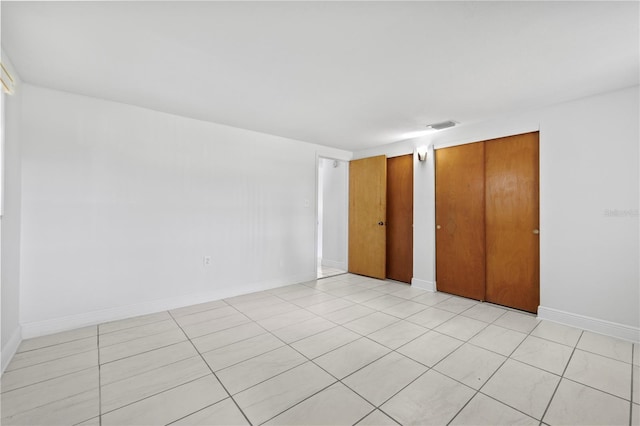 10730 Premier Ave, Port Richey, FL 34668 - unfurnished bedroom featuring two closets and light tile patterned flooring
