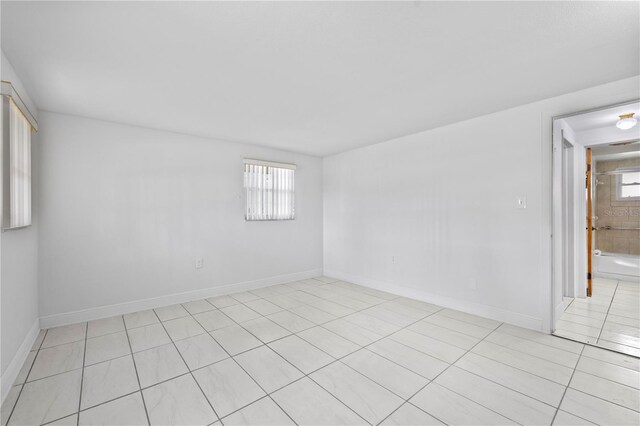 10730 Premier Ave, Port Richey, FL 34668 - empty room featuring plenty of natural light and light tile patterned floors