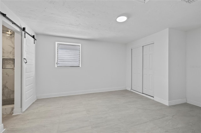10730 Premier Ave, Port Richey, FL 34668 - unfurnished bedroom with a barn door and a closet