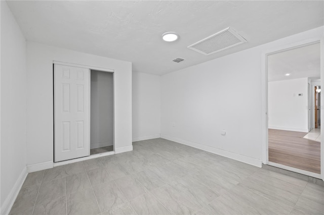 10730 Premier Ave, Port Richey, FL 34668 - unfurnished bedroom featuring baseboards and a closet
