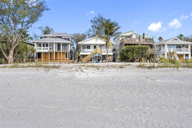12458 1st St W, Treasure Island, FL 33706 - view of front of house with a residential view and stairway
