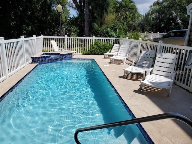12458 1st St W, Treasure Island, FL 33706 - view of pool featuring a pool with connected hot tub