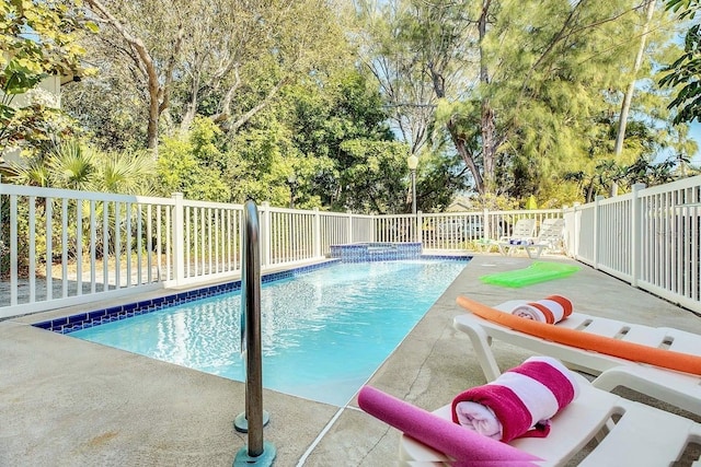 12458 1st St W, Treasure Island, FL 33706 - view of pool with view of wooded area and a patio area