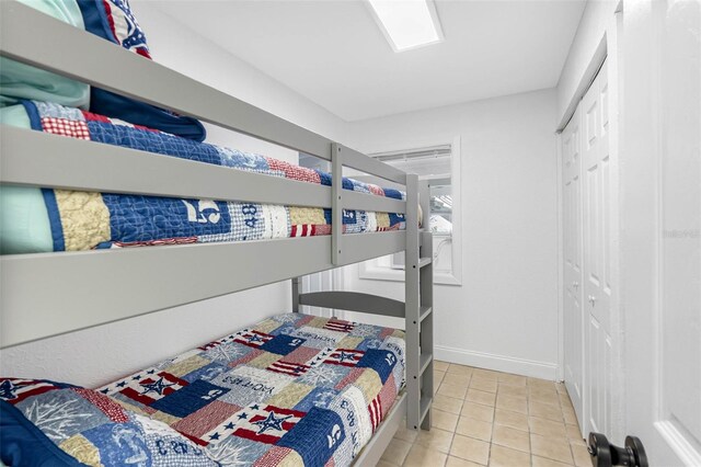 12458 1st St W, Treasure Island, FL 33706 - bedroom with tile patterned floors and a closet