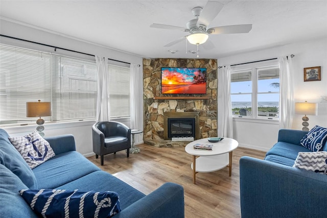 12458 1st St W, Treasure Island, FL 33706 - living area with a fireplace, wood finished floors, and a ceiling fan