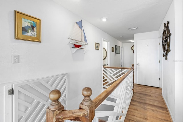 12458 1st St W, Treasure Island, FL 33706 - corridor featuring light wood finished floors and baseboards