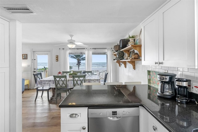 12458 1st St W, Treasure Island, FL 33706 - kitchen featuring dishwasher, open shelves, a peninsula, white cabinets, and wood finished floors