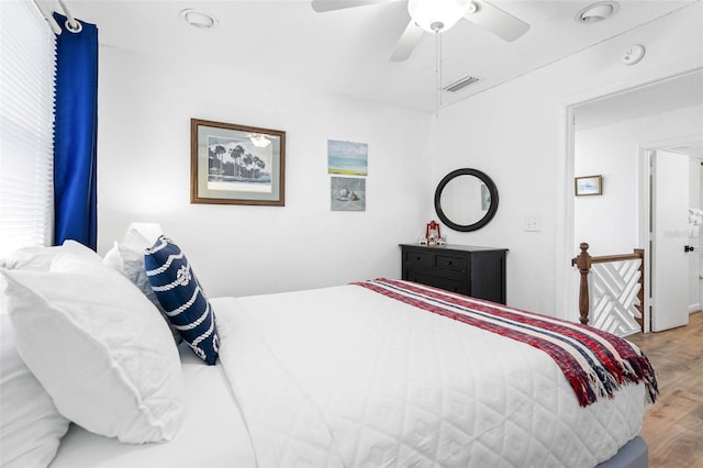 12458 1st St W, Treasure Island, FL 33706 - bedroom featuring wood finished floors and ceiling fan