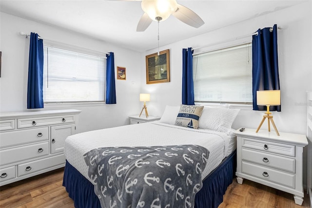 12458 1st St W, Treasure Island, FL 33706 - bedroom with wood finished floors and a ceiling fan