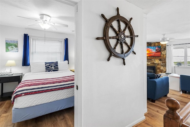 12458 1st St W, Treasure Island, FL 33706 - bedroom with wood finished floors and a fireplace