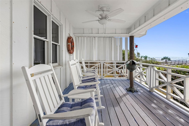 12458 1st St W, Treasure Island, FL 33706 - wooden terrace featuring a ceiling fan and a water view