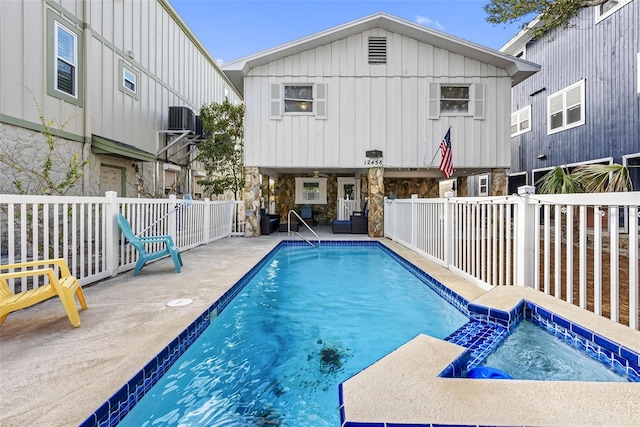 12458 1st St W, Treasure Island, FL 33706 - view of pool with a pool with connected hot tub and a patio