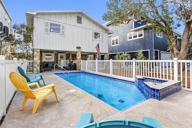 12458 1st St W, Treasure Island, FL 33706 - view of swimming pool with a patio, a pool with connected hot tub, and a ceiling fan