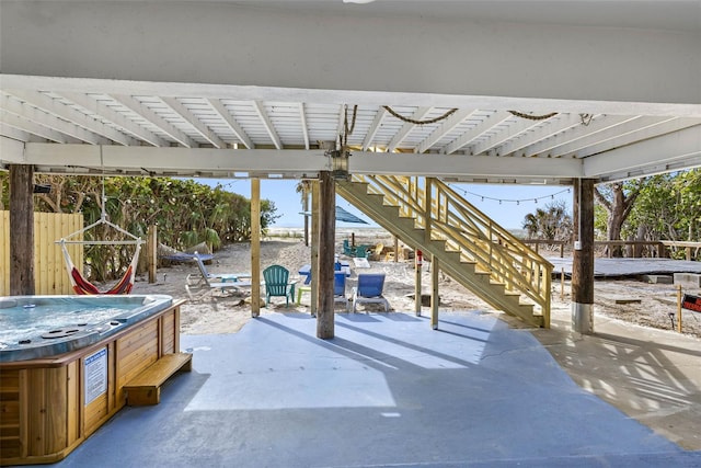 12458 1st St W, Treasure Island, FL 33706 - view of patio featuring stairway and a hot tub