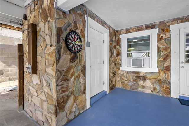 12458 1st St W, Treasure Island, FL 33706 - doorway to property with stone siding and cooling unit