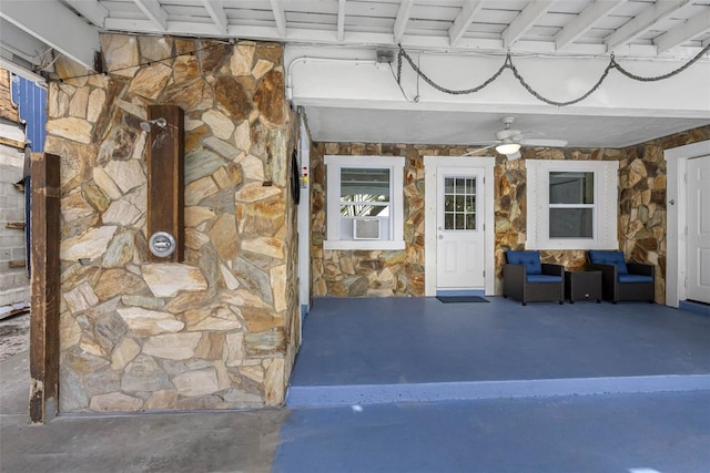 12458 1st St W, Treasure Island, FL 33706 - view of exterior entry with stone siding and a ceiling fan