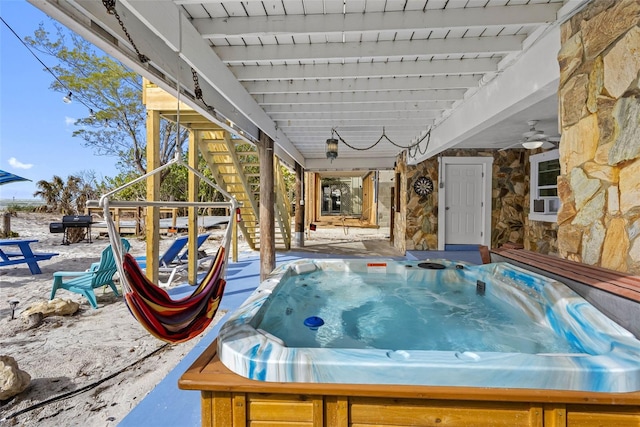 12458 1st St W, Treasure Island, FL 33706 - view of patio / terrace with stairway, a hot tub, and a grill