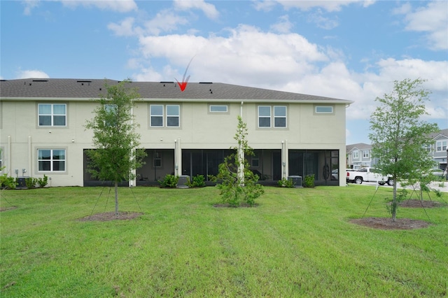26082 Woven Wicker Bnd, Lutz, FL 33559 - rear view of property featuring stucco siding, a lawn, and a sunroom