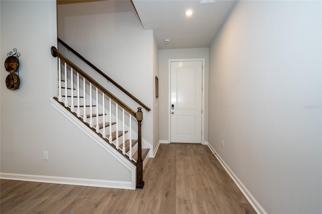 26082 Woven Wicker Bnd, Lutz, FL 33559 - stairs featuring wood finished floors and baseboards