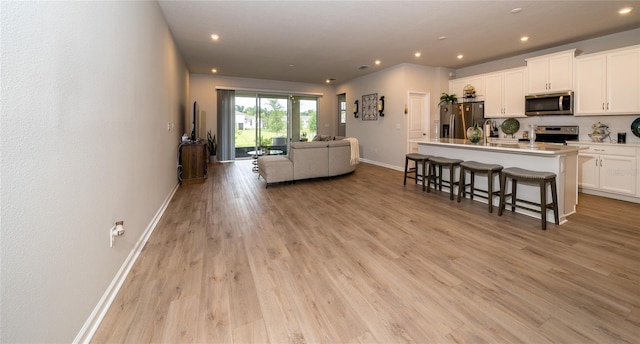 26082 Woven Wicker Bnd, Lutz, FL 33559 - living room featuring recessed lighting and light wood-type flooring