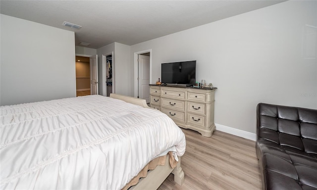 26082 Woven Wicker Bnd, Lutz, FL 33559 - bedroom with baseboards and light wood-style flooring